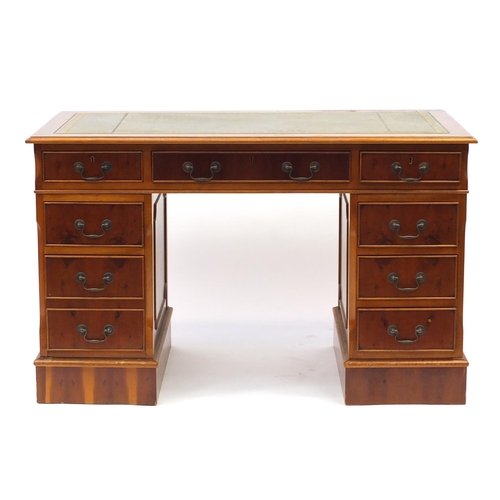 1 - Yew twin pedestal desk with tooled leather insert above a series of drawers, 78cm H x 124cm W x 60cm... 