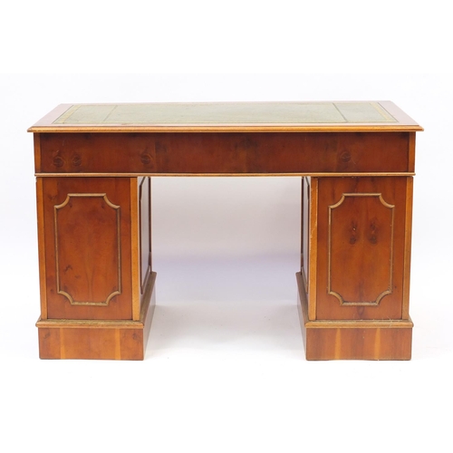 1 - Yew twin pedestal desk with tooled leather insert above a series of drawers, 78cm H x 124cm W x 60cm... 