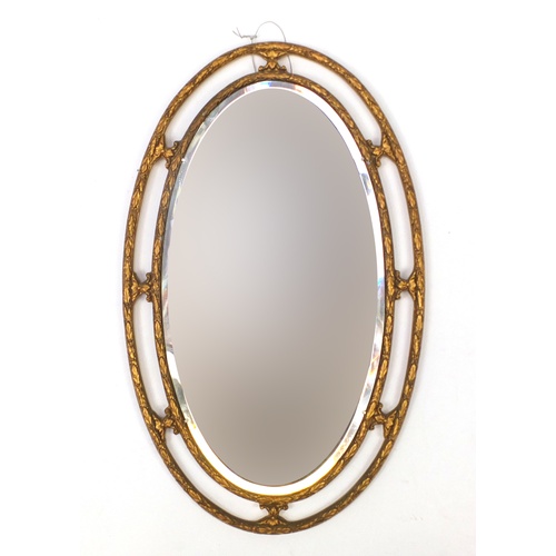 2071 - Oval gilt framed bevelled edge mirror, 70cm x 44cm