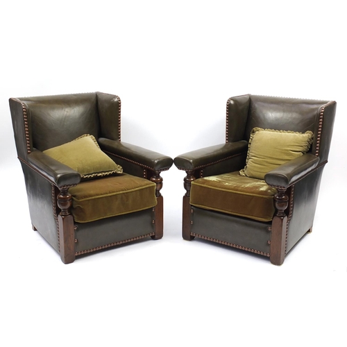2072 - Pair of oak framed green leather wingback armchairs, 84cm high
