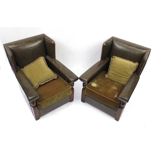 2072 - Pair of oak framed green leather wingback armchairs, 84cm high
