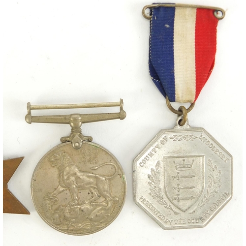 2882 - Three British military World War II medals and two 1935 silver jubilee medallions