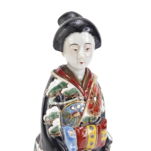 75 - Japanese porcelain figurine of a Geisha girl wearing a robe, 29cm high