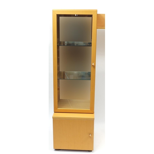 2130 - Beech illuminated wall unit by John Coyle, fitted with a series of cupboard doors, drawers and glass... 