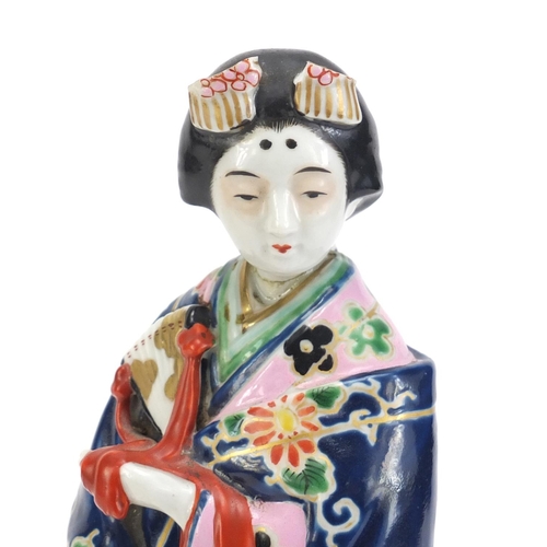2157 - Japanese porcelain figure of a Geisha girl wearing a robe, 30cm high