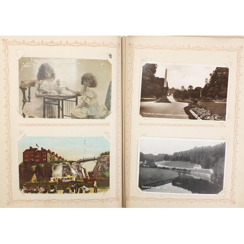 2671 - Edwardian and later mostly topographical postcards arranged in an album including street scenes