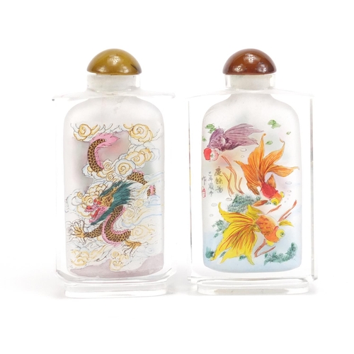 2860 - Two Chinese glass snuff bottles internally hand painted with dragons and fish, each 8.5cm high