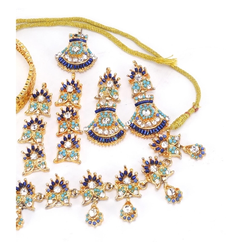 2835 - Indian gilt metal costume jewellery comprising two pendants, a pair of drop earrings, a necklace and... 