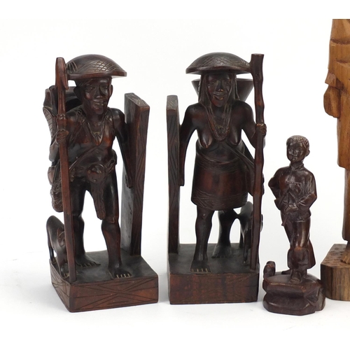 2421 - Three African carved wood figures and one of a Chinese boy, the largest 50cm high