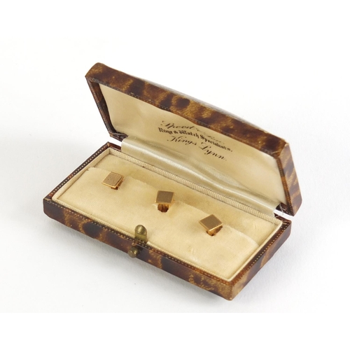 156 - Set of three 9ct  gold gentleman's studs, 2.8g, housed in a tooled leather fitted case