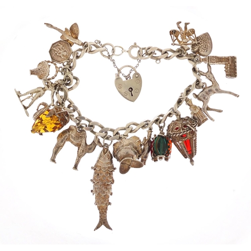 152 - Silver charm bracelet with a selection of mostly silver charms including articulated fish, camel and... 