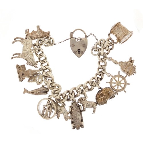 87 - Silver charm bracelet with a selection of mostly silver charms including bulldog, rhino, classic car... 