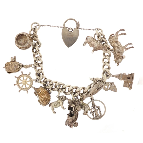 87 - Silver charm bracelet with a selection of mostly silver charms including bulldog, rhino, classic car... 