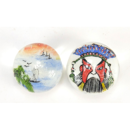 3016 - Two glass paperweights including one decorated with a Chinese Emperor, the largest 4.7cm in diameter