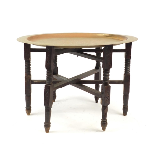 2123 - Mahogany and brass folding tray top table, 44cm high x 65cm in diameter