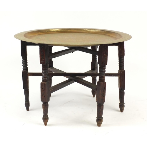2123 - Mahogany and brass folding tray top table, 44cm high x 65cm in diameter