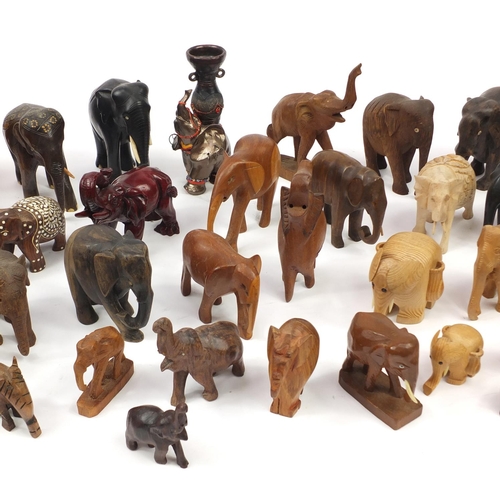 2468 - Large collection of mostly wooden elephants including some ebony, the largest 20cm high