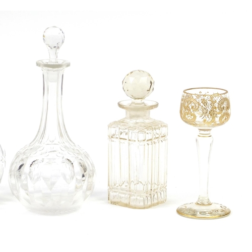 2285 - Glassware including a Continental etched and hand gilded glass and four decanters with stoppers