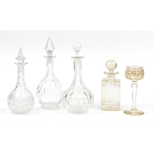 2285 - Glassware including a Continental etched and hand gilded glass and four decanters with stoppers