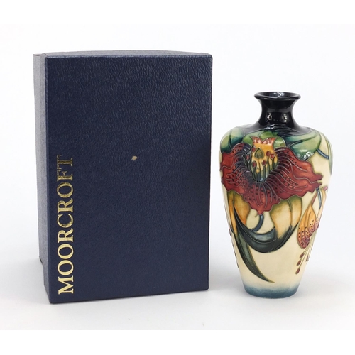 60 - Moorcroft pottery vase with box, hand painted with stylised flowers, 16cm high