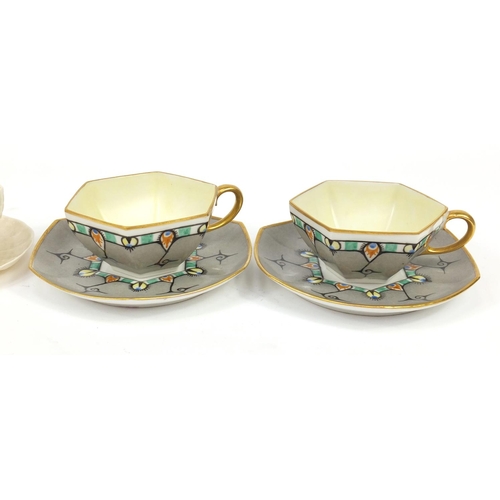 2634 - Two Irish Belleek cups and saucers and a pair of Art Deco Limoges cups and saucers