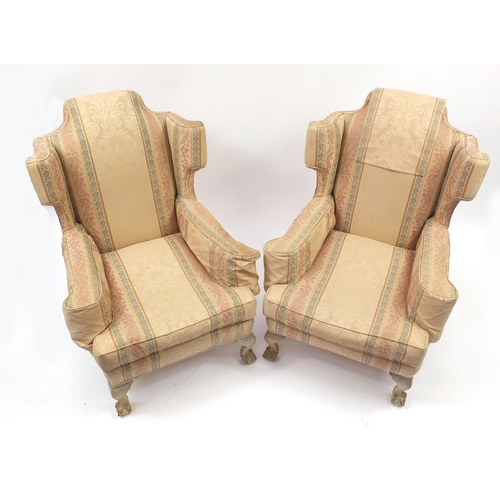 2013 - Pair of wingback armchairs with ball and claw feet and striped upholstery, 100cm high
