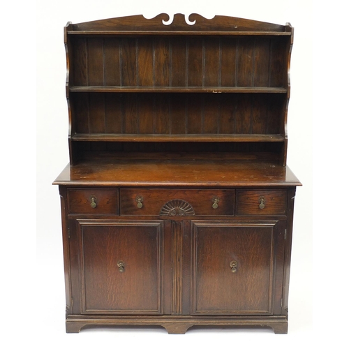 2068 - Oak dresser with open plate rack above three drawers and a pair of cupboard doors, with Birchcraft l... 