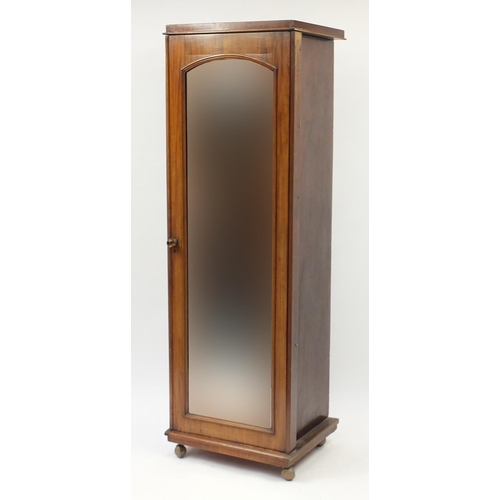 2118 - Walnut single wardrobe with mirrored door enclosing four pull out shelves above three drawers, 195cm... 