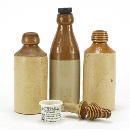 2246 - Three antique stoneware bottles and an ointment jar, the largest 22cm high