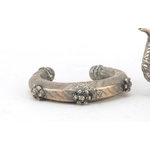 2763 - Tibetan Unmarked silver miniature teapot and two silver coloured metal slave bangles, the teapot 7cm... 