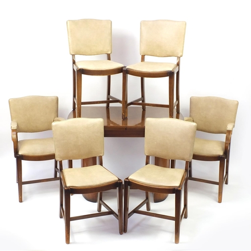 2005 - Art Deco walnut draw-leaf dining table and six chairs including two carvers with cream leather backs... 