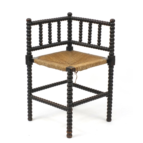 2057 - Antique bobbin turned corner chair with rush seat, 68cm high