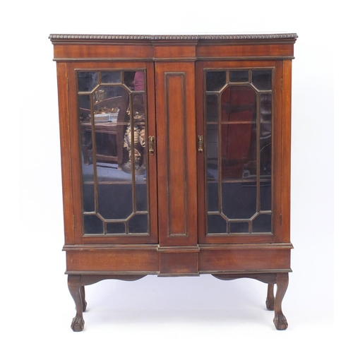 2004 - Mahogany breakfront bookcase fitted with a pair of glazed doors, raised on ball and claw feet, 133cm... 