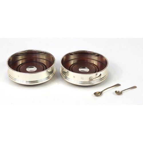 2737 - Pair of circular silver and oak wine coasters by Carrs and two silver mustard spoons, the coasters e... 