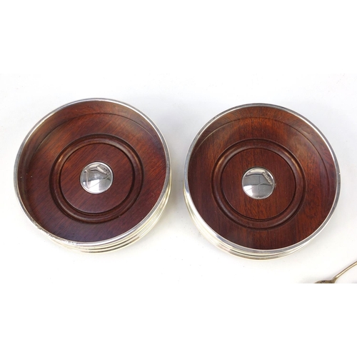 2737 - Pair of circular silver and oak wine coasters by Carrs and two silver mustard spoons, the coasters e... 