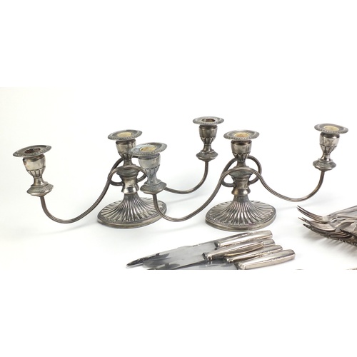 2333 - Pair of silver plated three branch candelabra and silver plated cutlery, the candelabra 38cm wide