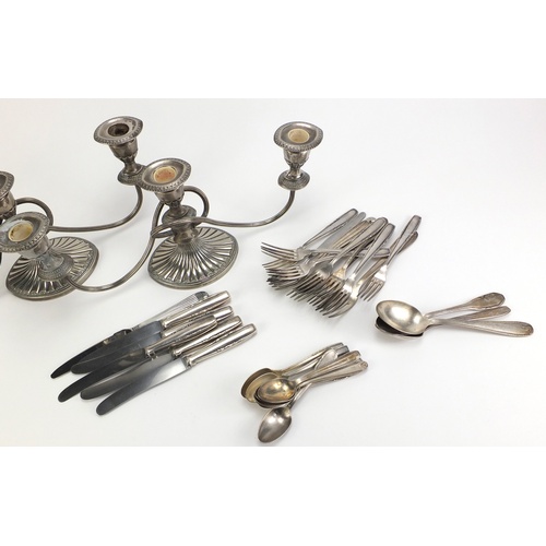 2333 - Pair of silver plated three branch candelabra and silver plated cutlery, the candelabra 38cm wide