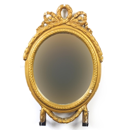 2158 - Oval gilt framed mirror with swag design, 49cm high