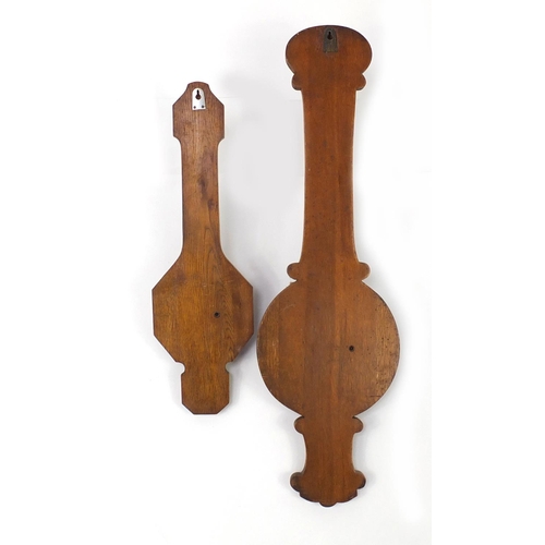 2124 - Two oak aneroid wall barometers with thermometers, the largest 89cm high