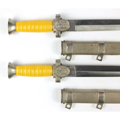 2956 - Two German military interest daggers with scabbards, 39cm in length