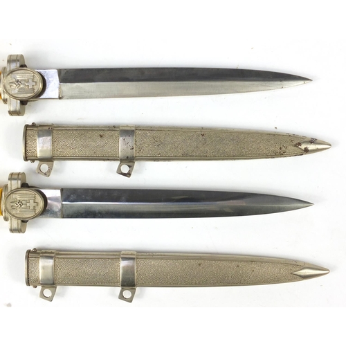 2956 - Two German military interest daggers with scabbards, 39cm in length