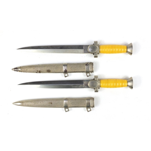 2956 - Two German military interest daggers with scabbards, 39cm in length