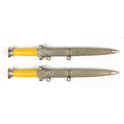 2956 - Two German military interest daggers with scabbards, 39cm in length