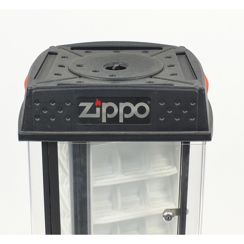 2069 - Zippo lighter illuminated rotating display case, 93cm high