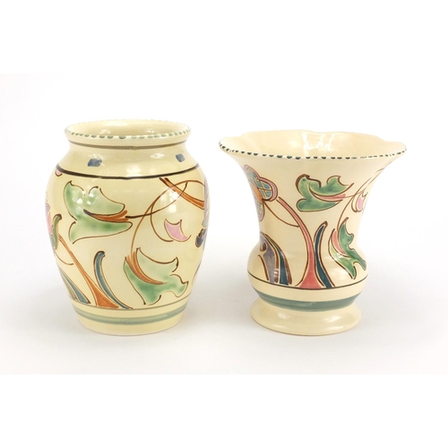 2646 - Two Honiton vases, both hand painted with stylised flowers, the largest 18cm high