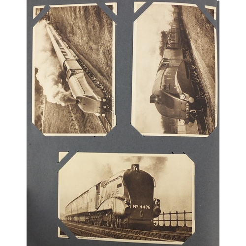 2675 - Mostly Edwardian postcards including steam locomotives and military examples arranged in an album