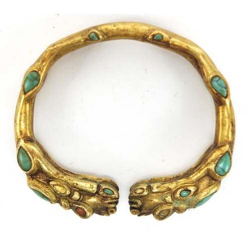 2980 - Tibetan gilt metal dragon bangle set with coral and turquoise, 7.5cm wide