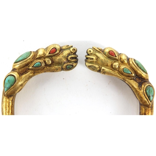 2980 - Tibetan gilt metal dragon bangle set with coral and turquoise, 7.5cm wide