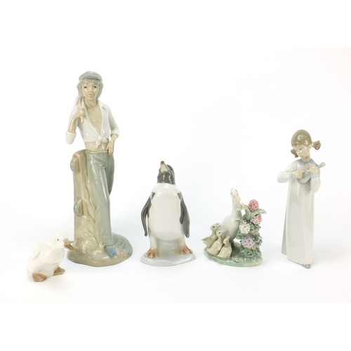 770 - Collectable china including Lladro penguin and figurine of a girl holding an instrument, the largest... 