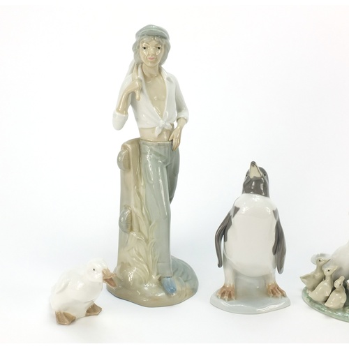 770 - Collectable china including Lladro penguin and figurine of a girl holding an instrument, the largest... 